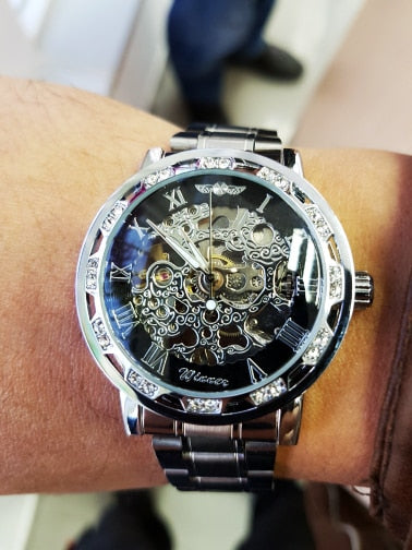 silver luxury watch on man's wrist