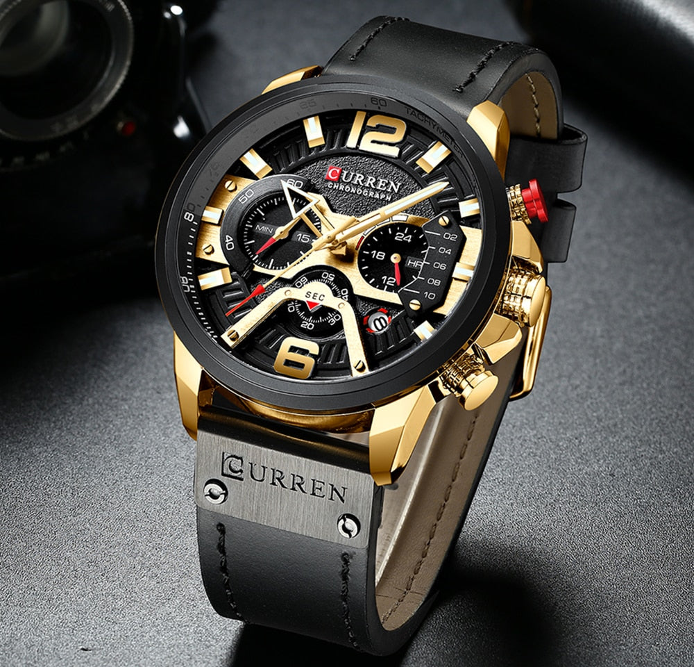 black gold with black leather band watch