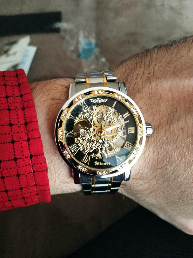 red luxury watch on man's wrist
