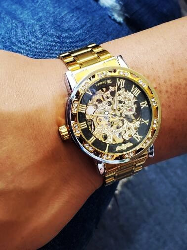 gold luxury watch on man's wrist